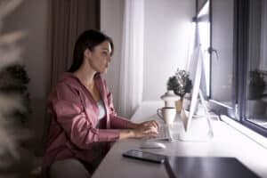 A lady in front of a computer, working from home